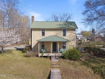 Charming two-story home with a covered front porch and a well-maintained lawn at 2409 Hodges Rd, Burlington, NC 27217