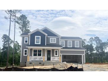 Two-story home with gray siding and a covered porch, awaiting its final touches at 266 Golfview Ave, Benson, NC 27504