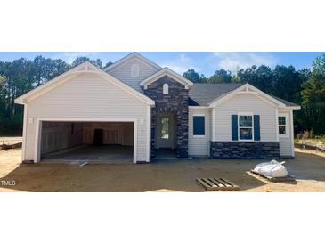 Charming single-Gathering home with stone accents, an attached garage, and classic architectural details at 283 Golfview Avenue, Benson, NC 27504