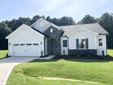 Charming single-story home with stone accents, attached garage, and well-manicured lawn at 283 Golfview Avenue, Benson, NC 27504