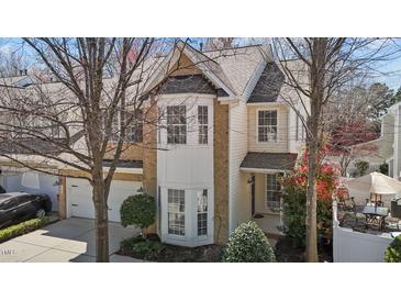 Charming two-story home with a blend of brick and vinyl siding, complemented by a well-manicured front yard at 3509 Archdale Dr, Raleigh, NC 27614