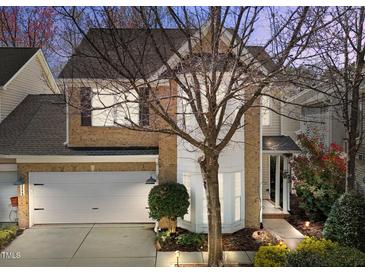 Inviting two-story brick home with a well-manicured lawn and attached two-car garage at 3509 Archdale Dr, Raleigh, NC 27614