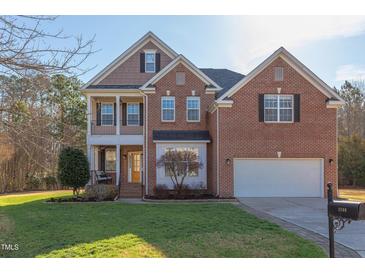 Beautiful two-story brick home with well-manicured lawn and attached two-car garage at 3708 Tansley St, Wake Forest, NC 27587
