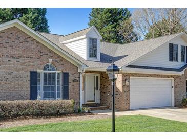 Charming brick home with manicured lawn, two-car garage, and covered entrance at 505 #106 Alamance Rd, Burlington, NC 27215