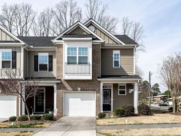 Charming townhouse featuring a brick facade and a one-car garage at 700 Treviso Ln, Apex, NC 27502