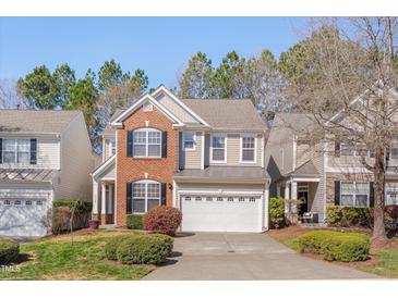 Charming two-story home with brick and siding, well-manicured lawn, and two car garage at 7920 Leonardo Dr, Durham, NC 27713