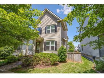 Charming two-story home with a well-manicured lawn and inviting curb appeal, showcasing a cozy residential atmosphere at 105 Della St, Chapel Hill, NC 27516