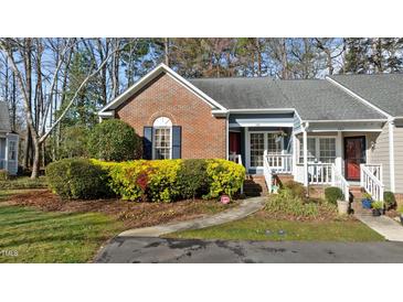Charming brick exterior of a well-kept townhome with lovely landscaping at 1101 Esher Ct, Raleigh, NC 27609