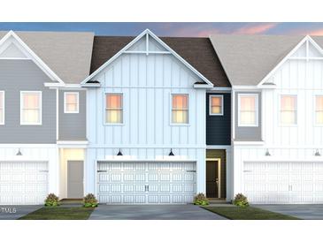 Charming townhome featuring an attached garage and a beautifully designed modern exterior at 1115 Everton Ave, Durham, NC 27703