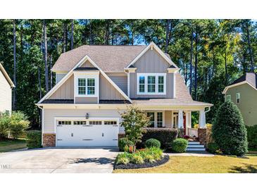 Charming two-story home with manicured landscaping and a welcoming front porch at 2739 Elderberry Ln, Apex, NC 27539