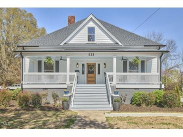 Charming home featuring a welcoming front porch, well-manicured landscaping, and a classic architectural design at 523 N Main St, Graham, NC 27253