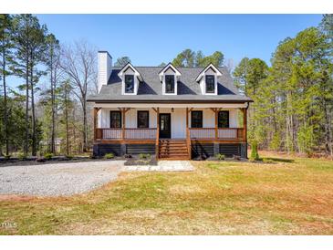 Charming two-story home with a inviting front porch and well-manicured landscaping at 692 Port Dr, Henderson, NC 27537