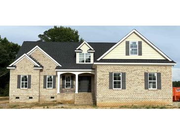 Inviting brick home featuring a covered front porch and classic architectural details at 835 Emmett Ct, Spring Hope, NC 27882