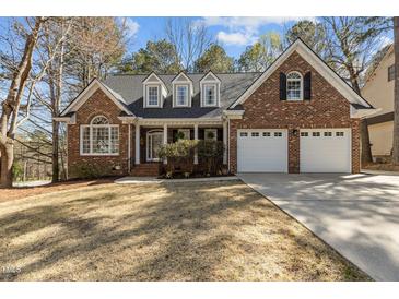 Charming brick home with a well-manicured lawn and a two-car garage, perfect for families at 101 Barriedale Cir, Cary, NC 27519