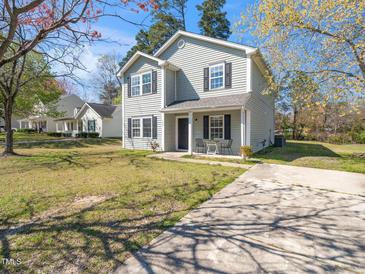 Charming two-story home with a well-maintained lawn, concrete driveway, and a quaint front porch at 106 Mingocrest Dr, Knightdale, NC 27545