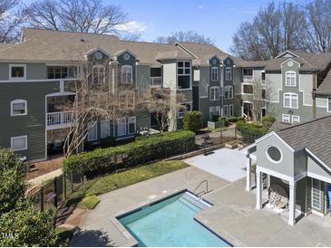 Inviting apartment complex featuring a pool, charming balconies, and lush landscaping offers a comfortable living environment at 1121 Parkridge Ln # 207, Raleigh, NC 27605
