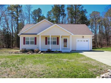 Charming single-Gathering home featuring a well-manicured lawn and attached one-car garage at 1220 E Middleton Dr, Creedmoor, NC 27522