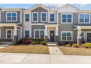 Charming two-story townhome with a landscaped front yard and inviting entrance at 1805 Kauri Cliffs Dr, Fuquay Varina, NC 27526