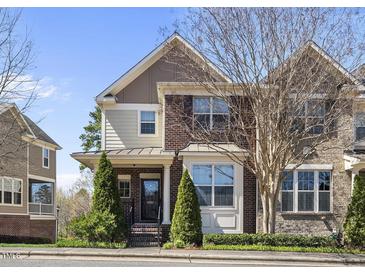 Beautiful brick and siding townhome with manicured landscaping on a sunny day at 3001 Valleystone Dr, Cary, NC 27519