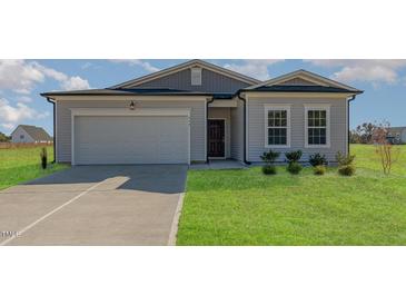 Charming single-Gathering home featuring a two-car garage and well-manicured lawn at 402 Suhani Ln, Clayton, NC 27520