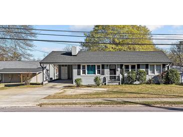 Charming single-story home featuring a grey brick facade, covered carport, and well-maintained front yard at 539 N Oneil St, Clayton, NC 27520