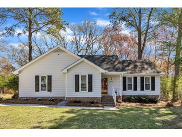 Charming one-story home featuring a well-manicured lawn and classic white siding with black shutter accents at 5508 Lake Garden Ct, Raleigh, NC 27610