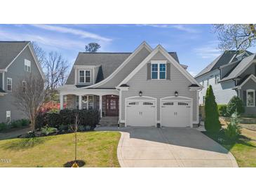 Charming home featuring a two-car garage, and well-maintained landscaping at 5811 Shawood Dr, Raleigh, NC 27609