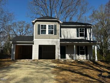 Two-story home featuring a gray color scheme, dual garage, and black shutters at 109 Forest Dr, Graham, NC 27253