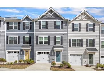 Charming townhomes featuring varied exteriors, attached garages, and meticulously maintained landscaping at 1107 Pale Moss Dr, Durham, NC 27704
