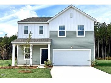 Charming two-story home with a two-car garage, manicured lawn, and welcoming front porch at 1114 Centerview Drive, Nashville, NC 27856