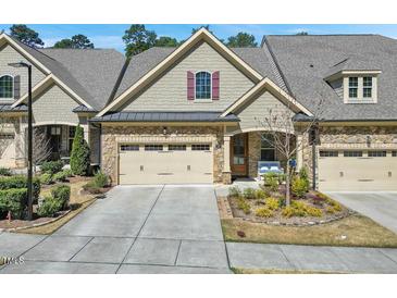 Charming townhouse with a two-car garage and landscaped front yard at 147 Glenpark Pl, Cary, NC 27511