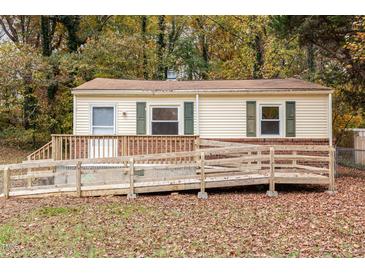 Charming home featuring a wheelchair ramp and wood facade and brick skirting at 164 Torain St, Hillsborough, NC 27278