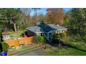 Beautiful single-story home with brick exterior, a well-maintained yard, and a charming front porch at 1805 Lawrence Rd, Hillsborough, NC 27278