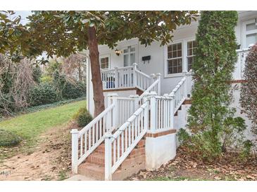 Charming front entrance with brick stairs, white railings, and a well-kept lawn at 1921 Clark Ave # 105, Raleigh, NC 27605