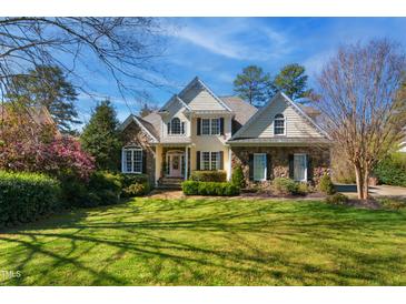Charming stone and siding home with well-manicured lawn and mature landscaping at 2613 Forest Lake Ct, Wake Forest, NC 27587