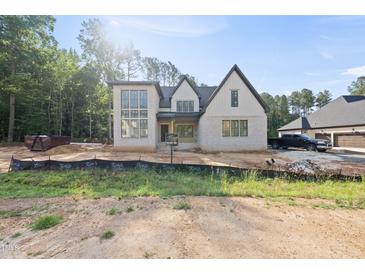 Striking two-story new construction home with brick and siding and an attached garage at 2957 Wexford Pond Way, Wake Forest, NC 27587