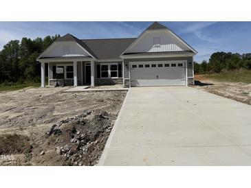 New construction home with a gray exterior, white trim, and a concrete driveway at 4013 Kingcraig Ln, Zebulon, NC 27597