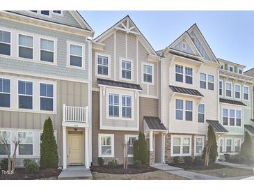 Charming townhomes feature varied exteriors, manicured lawns, and inviting entryways, creating a welcoming street view at 590 Grand Central Sta, Apex, NC 27502