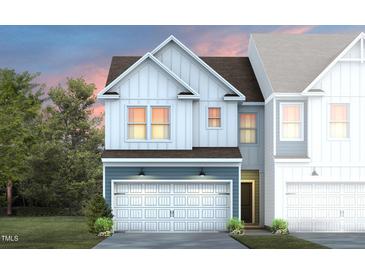 Charming two-story home featuring a white garage door and blue accents at 6000 Enclosure Way, Durham, NC 27703