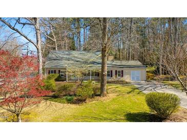 Charming single-story home with a manicured lawn, mature trees, and inviting curb appeal at 901 Emory Ln, Raleigh, NC 27609