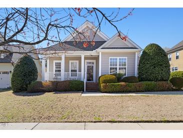 Charming single-story home featuring a cozy front porch and well-maintained landscaping at 922 Tupelo Glen Ct, Fuquay Varina, NC 27526