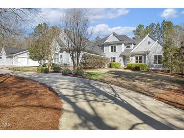 Charming two-story home with landscaped yard, and a long driveway, set back from the street at 113 Valley Ln, Pittsboro, NC 27312