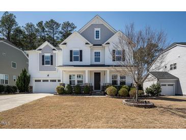 Charming two-story home featuring a manicured lawn and an attached two-car garage at 117 Gravel Brook Ct, Cary, NC 27519