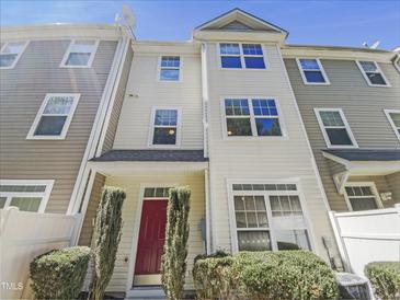 Attractive townhouse featuring a red front door and landscaped entryway at 11700 Coppergate Dr # 105, Raleigh, NC 27614