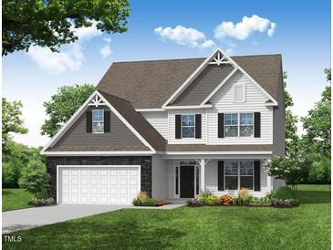 Charming two-story home featuring a stone-accented garage, complemented by black shutters and a well-manicured lawn at 1922 Cricket St, Elon, NC 27244