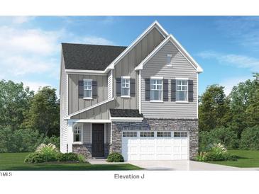 Charming two-story home featuring stone accents, gray siding, and a two-car garage for modern curb appeal at 228 Nahunta Dr, Apex, NC 27539