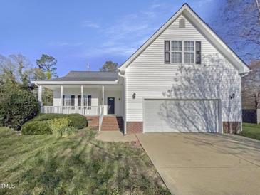 Charming two-story home with attached two car garage, front porch, and well maintained lawn at 48 Delmar Ct, Fuquay Varina, NC 27526