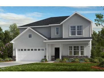 Charming two-story home with stone accents and a spacious two-car garage at 664 Sun Meadow Dr, Wake Forest, NC 27587