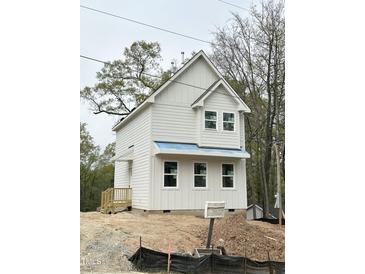 Charming new construction with white siding and a classic gable roof design at 908 Colfax St, Durham, NC 27701