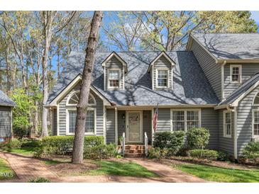 Charming home featuring a brick walkway, dormer windows, and well-maintained landscaping at 131 Long Shadow Ln, Cary, NC 27518